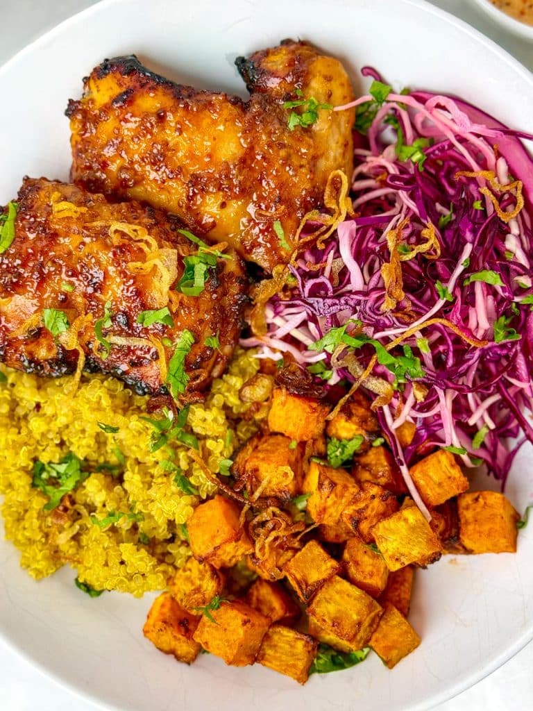 Sweetgreen hot honey chicken bowl with quinoa, sweet potatoes, cabbage slaw, and crispy shallots