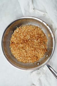 Toasted panko breadcrumbs golden brown in a skillet