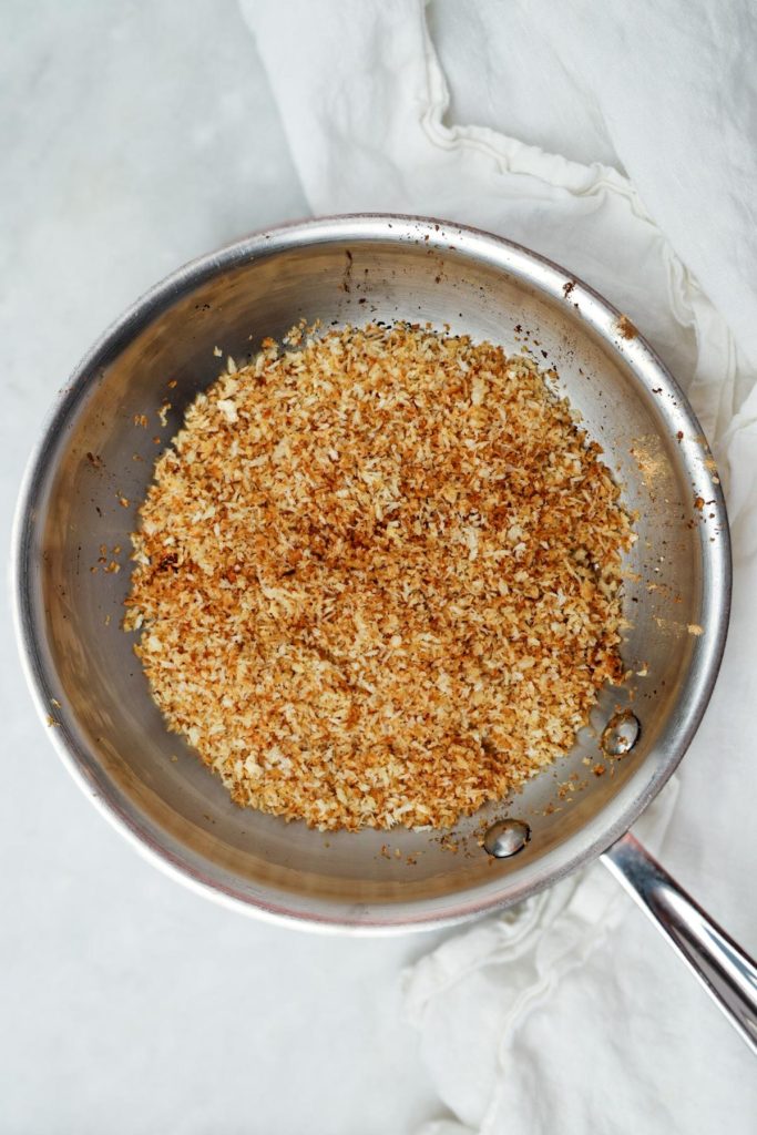 Toasted panko breadcrumbs golden brown in a skillet