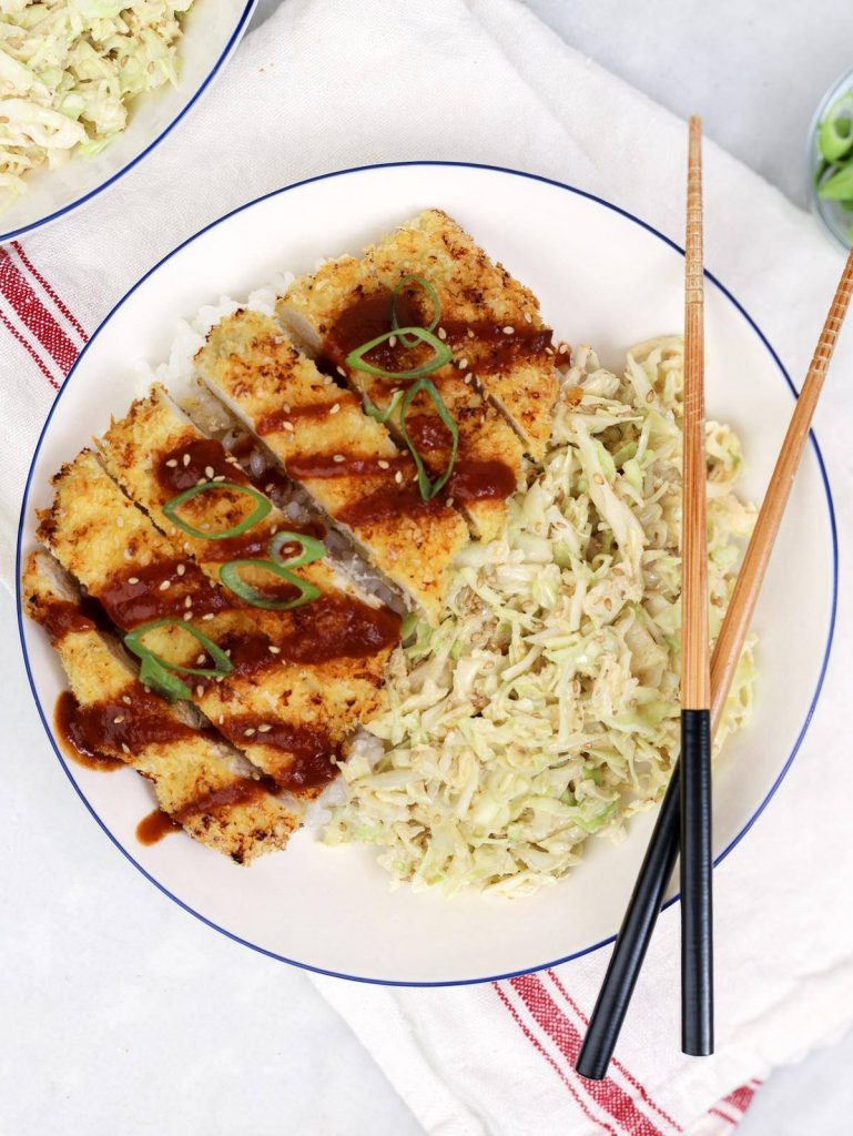 Air fryer chicken katsu recipe served bowl-style with rice, sesame slaw, and tonkatsu sauce drizzle