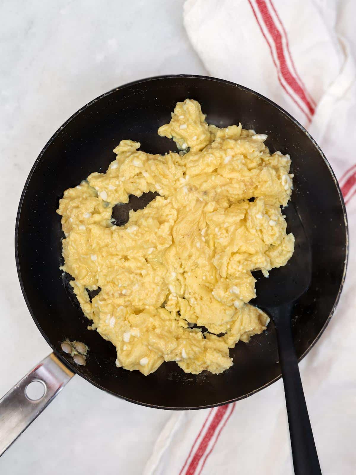 Soft-scrambled cottage cheese eggs in a nonstick skillet, the filling for high-protein breakfast tacos