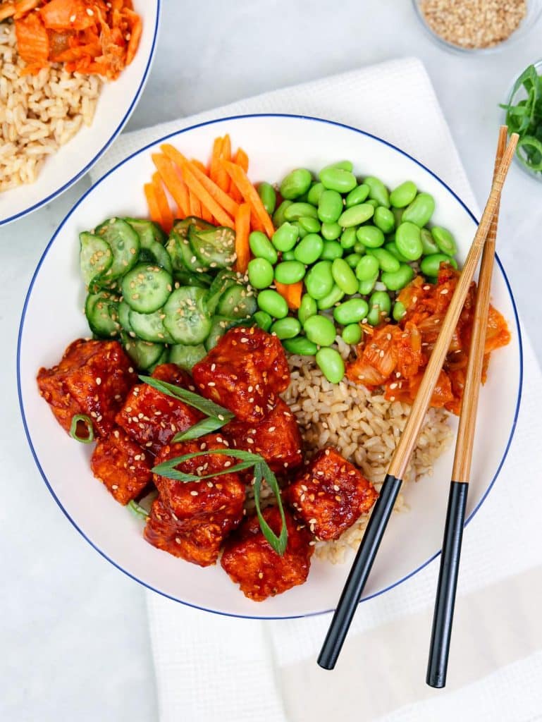 High protein tofu bowl with crispy gochujang tofu, brown rice, edamame, and pickled cucumber
