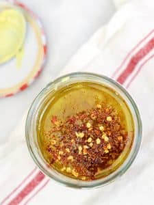 Garlicky lemon dressing with chili flakes in a glass jar