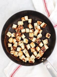 Cubed halloumi pan-fried until golden in a nonstick skillet