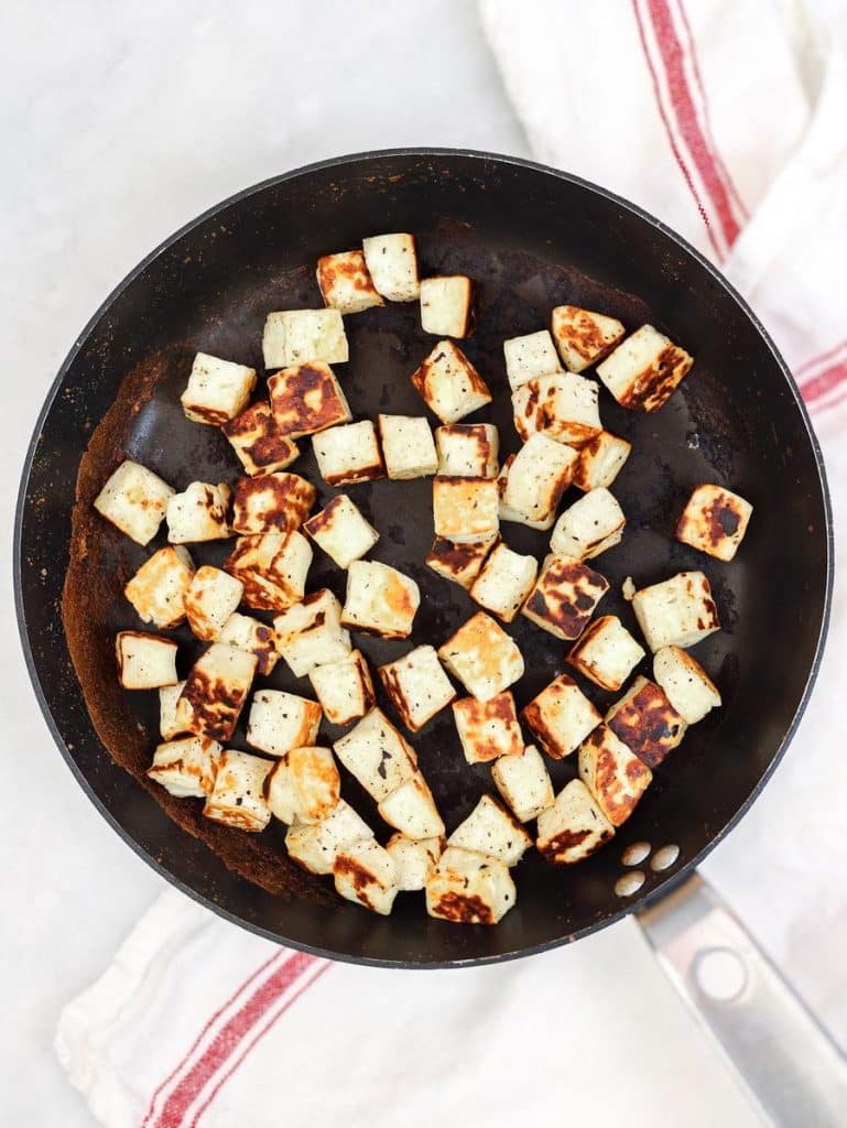 Cubed halloumi pan-fried until golden in a nonstick skillet