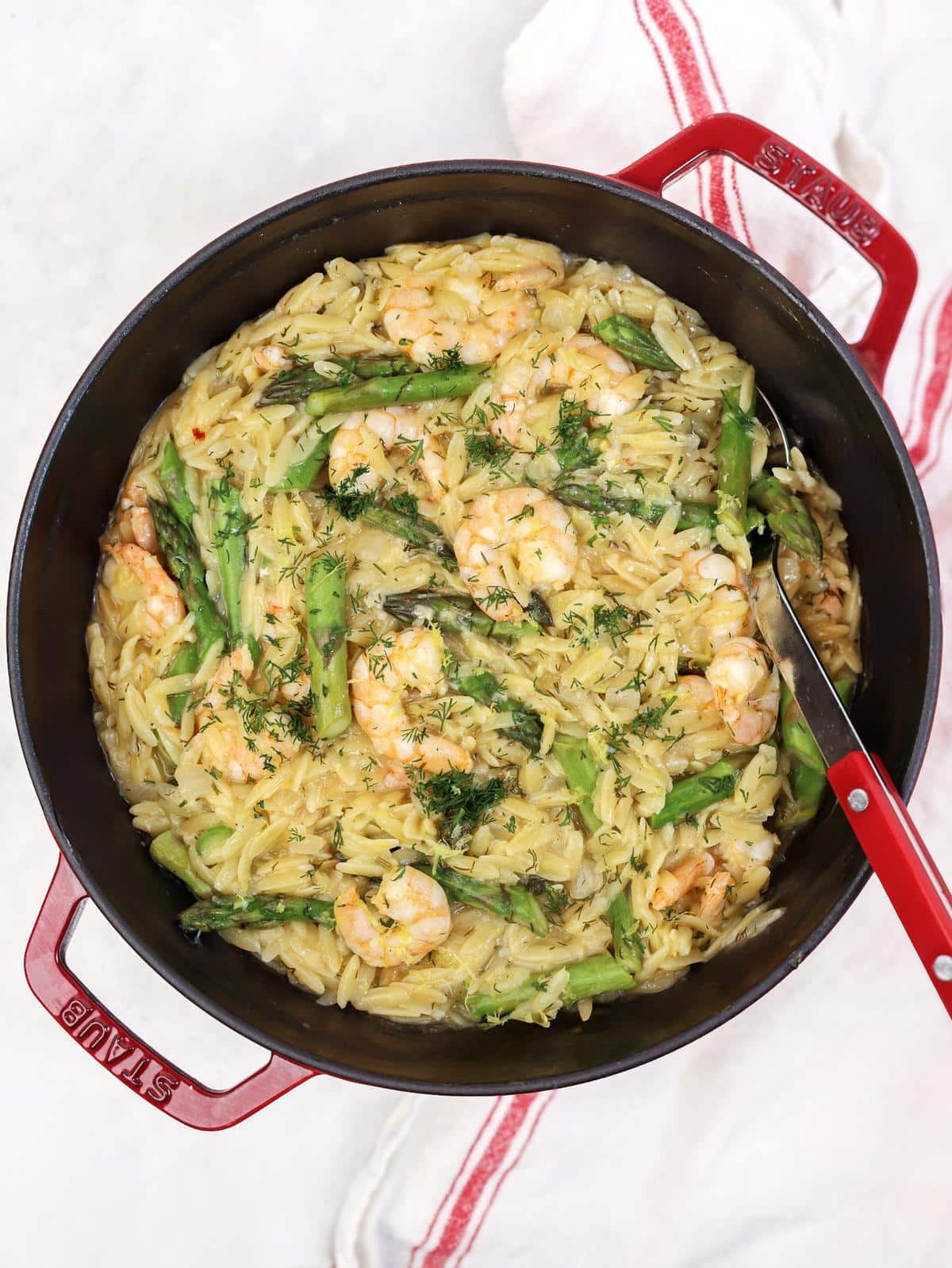 Overhead view of shrimp and asparagus orzo with parmesan and dill