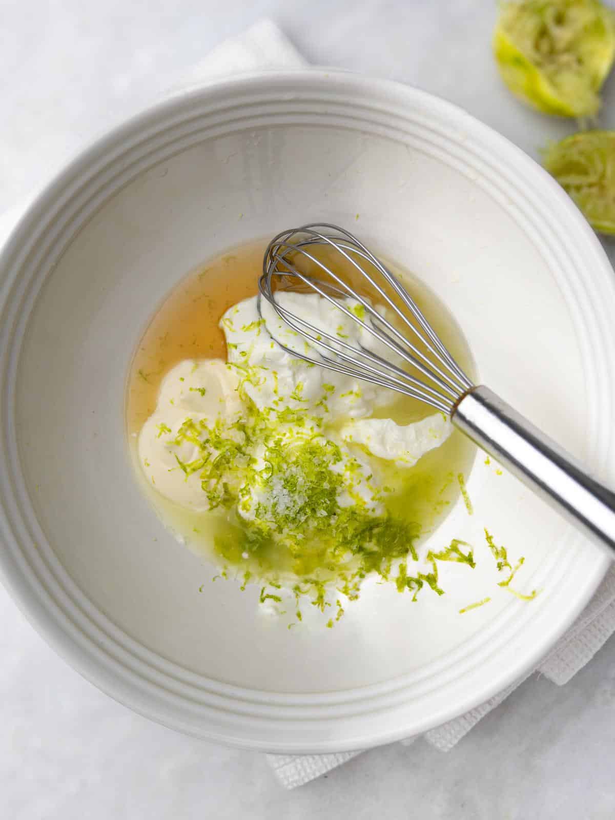 Greek yogurt, mayo, and lime zest in a bowl for cashew chicken salad dressing