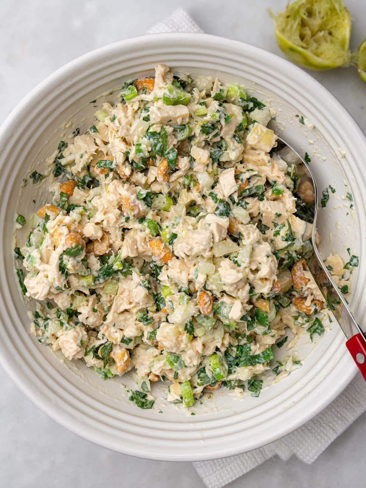 Cashew chicken salad recipe mixed in a white bowl with a spoon