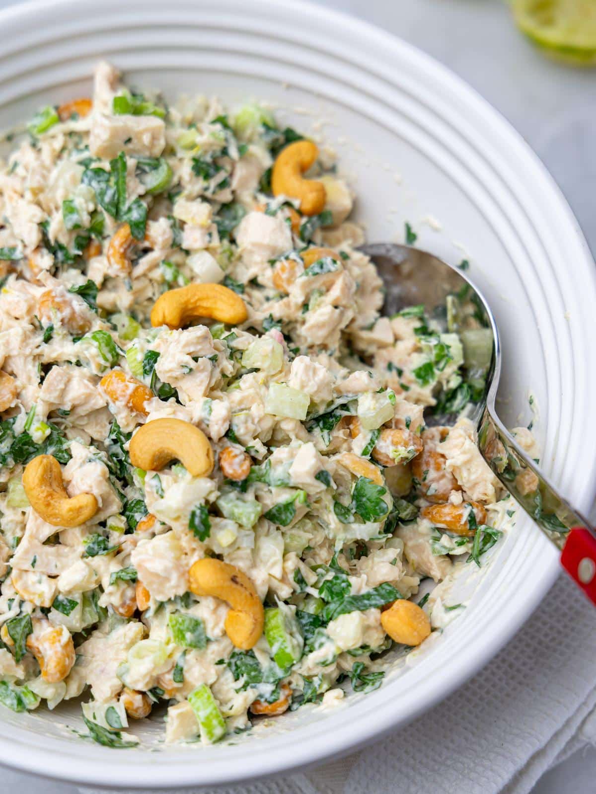 Close-up of creamy cashew chicken salad with mayonnaise and toasted cashews