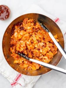 Diced chicken thighs tossed in chipotle adobo marinade in a bronze bowl