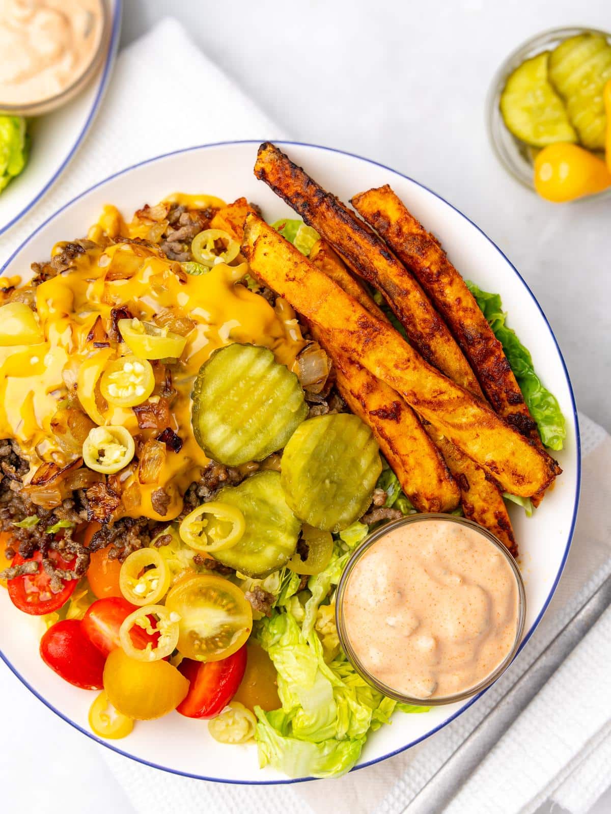 high protein burger bowl with crispy air fryer fries, mustard beef, pickles, and special sauce