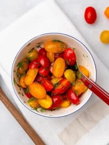 Marinated cherry tomatoes with fresh dill in a bowl