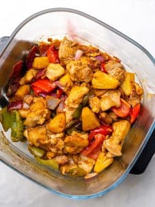 Air fryer hawaiian chicken with caramelized pineapple, bell peppers, and red onion in a sticky glaze
