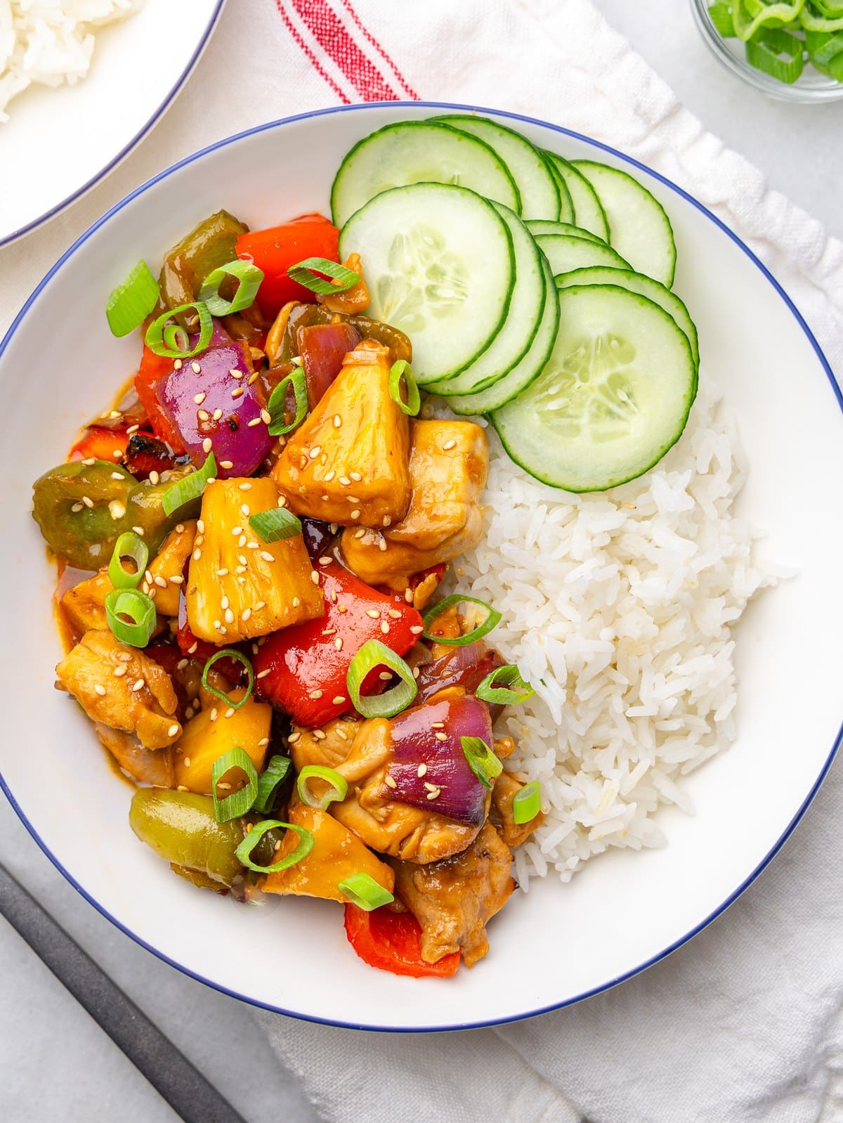 Hawaiian pineapple chicken with bell peppers and red onion in a sticky glaze over jasmine rice