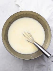 Egg whites and cottage cheese whisked together in a bowl for a high protein breakfast burrito filling