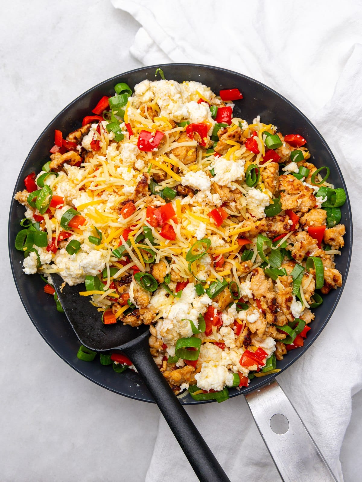 Skillet filling for high protein breakfast burritos with egg whites, sausage, cheese, and green onions