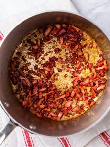 Crispy chopped bacon in a saucepan for autumn couscous salad