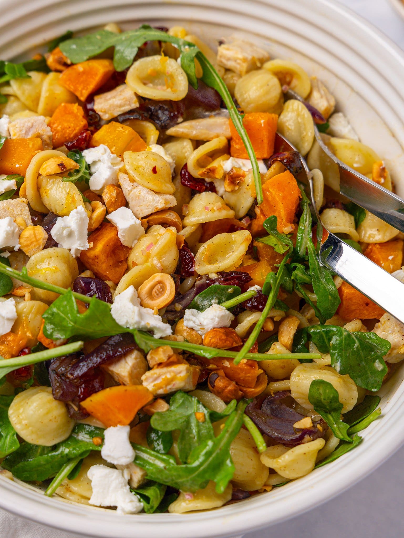 Close-up of pasta salad for fall with orecchiette, roasted butternut squash and crumbled goat cheese
