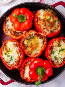 Stuffed peppers recipe with bubbly browned mozzarella and two pepper tops set back on as lids